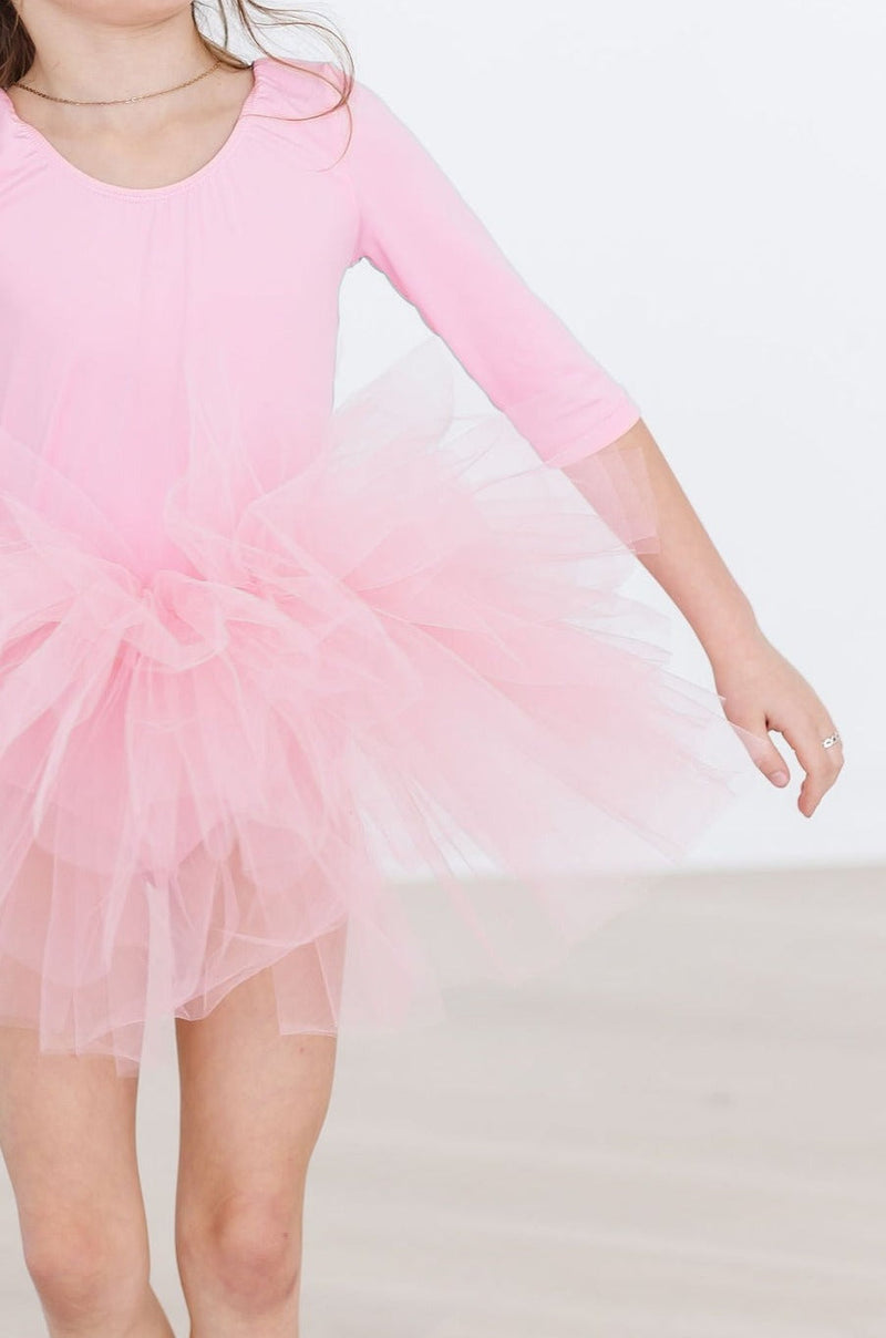 Little dancer twirling in the Bubblegum Pink 3/4 Tutu Leotard, emphasizing the vibrant color and playful design.