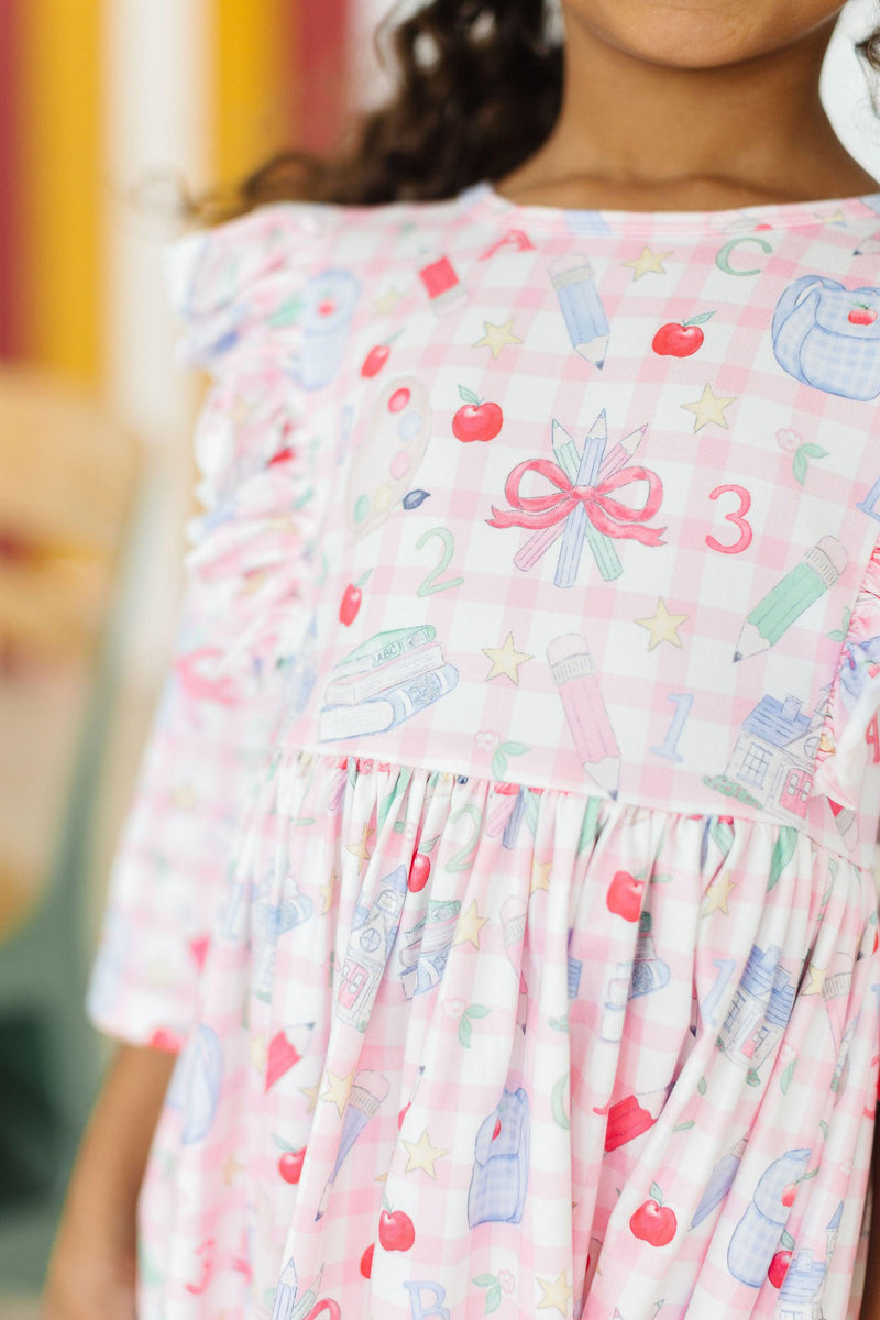 Close-up of the cute patterns on the School Days 3/4 Ruffle Twirl Dress by Mila & Rose ®, featuring school-themed graphics.