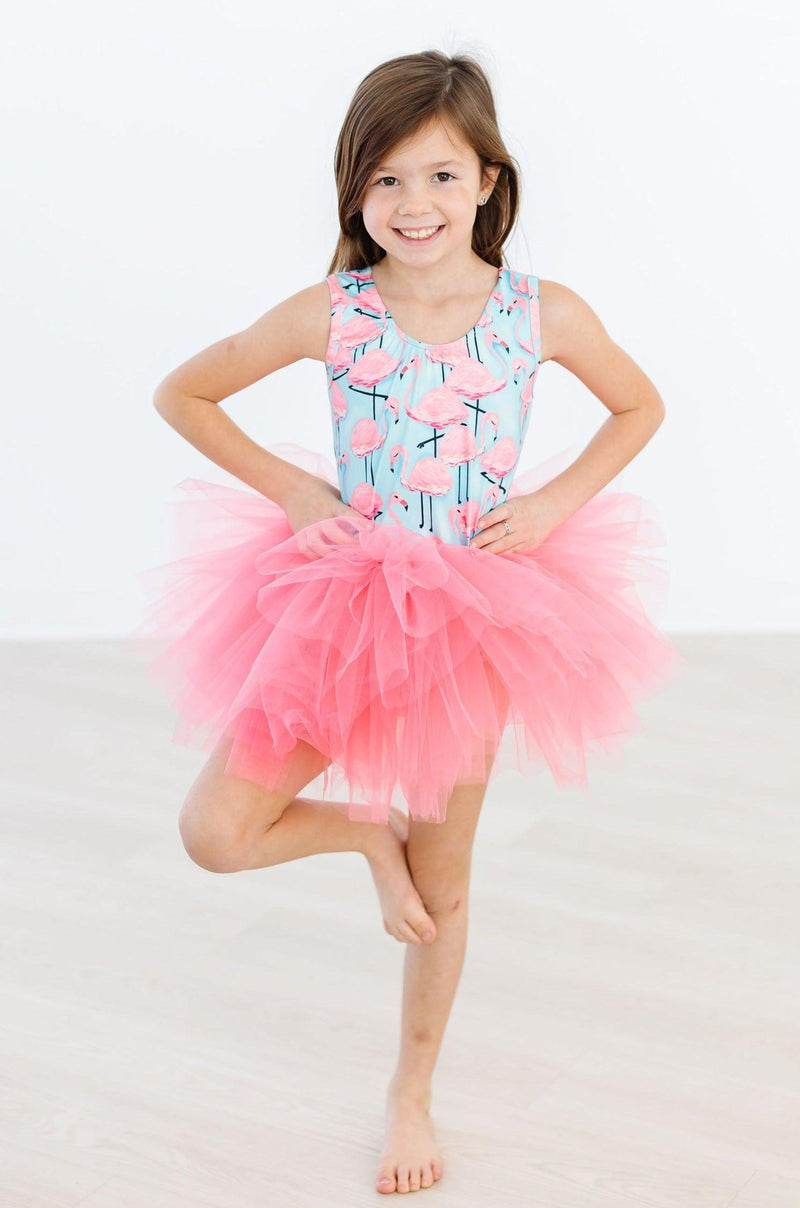 Young dancer wearing the Pretty in Pink Flamingos Tank Tutu Leotard by Mila & Rose, showcasing a vibrant flamingo print with a fluffy pink tutu, perfect for dance classes and play.