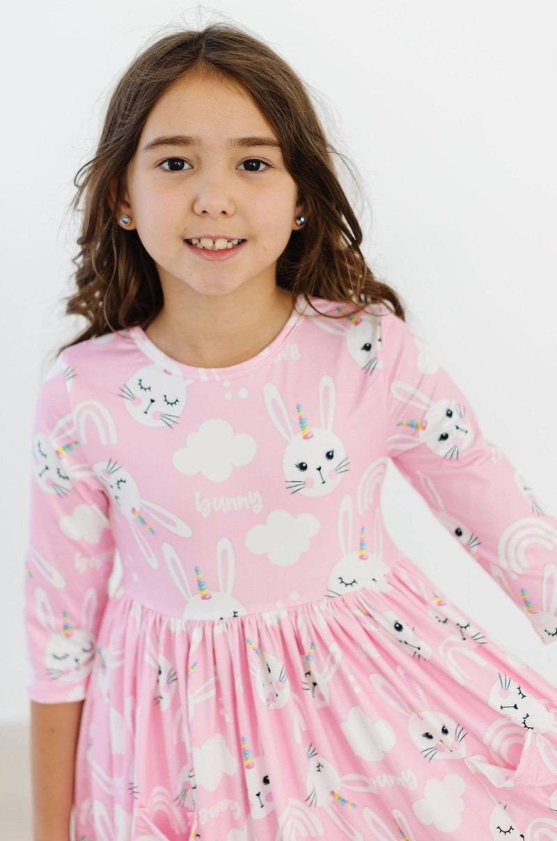 Close-up of the colorful fabric and playful scoop back of the Bunny Love 3/4 Sleeve Pocket Twirl Dress for Girls.