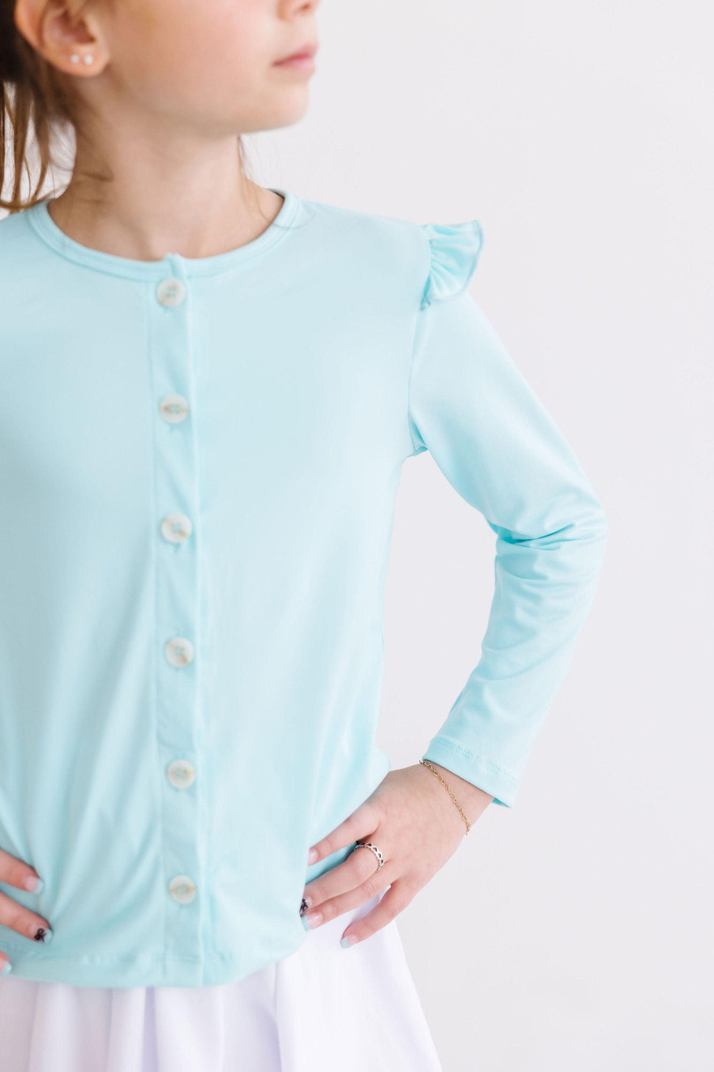 Charming Girl's Aqua Ruffle Cardigan by Mila & Rose, perfect for playful adventures and cozy classroom moments.