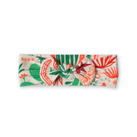 The SoftKnot Bow in Desert Cactus beige fabric tied on a gift box.