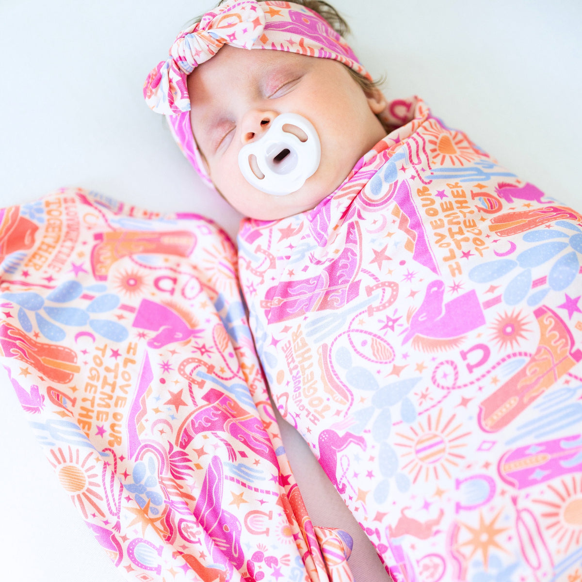 The Forever Large Swaddle Blanket in Saddle Up Western theme, a versatile and stylish baby essential.