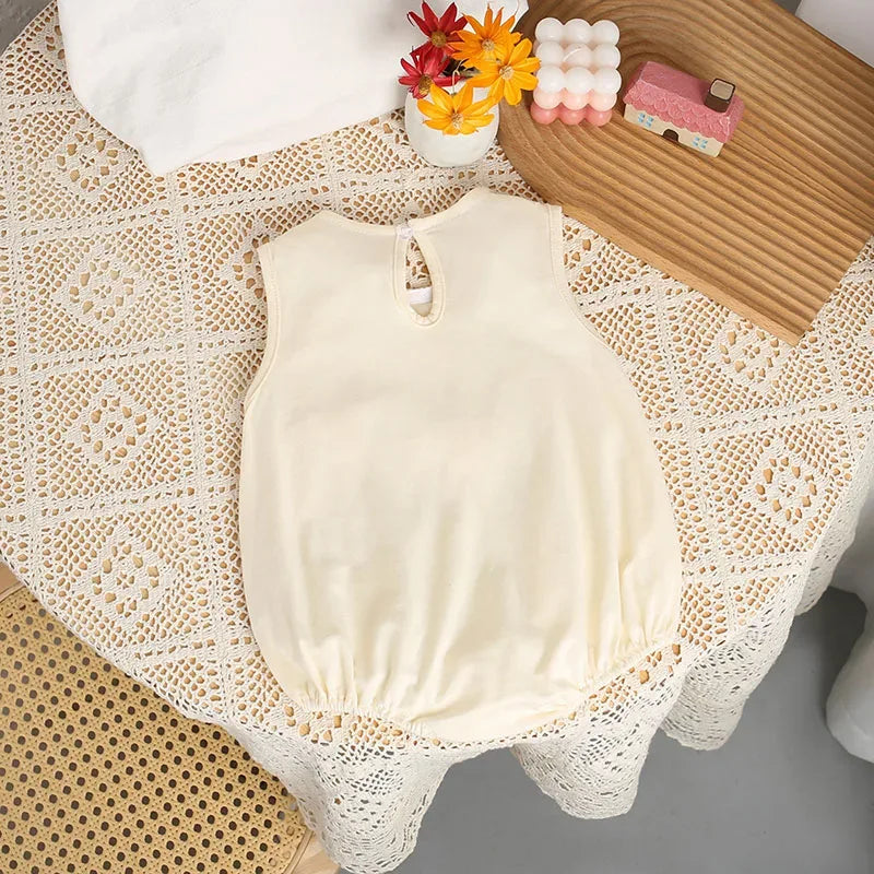 Cream 3D baby romper for infants with sleeveless design and gathered waist detail