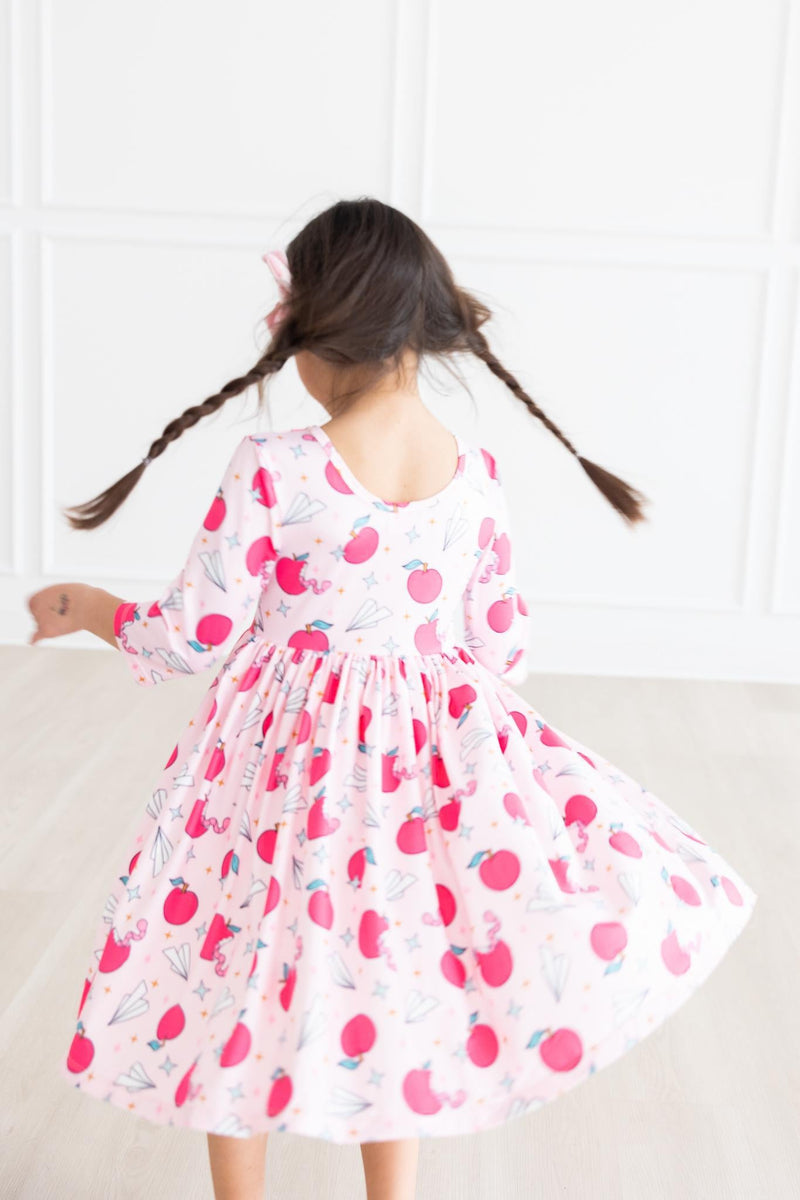 Girl twirling in the Star Student 3/4 Sleeve Pocket Twirl Dress by Mila & Rose®, demonstrating the full skirt and ease of movement for active play.