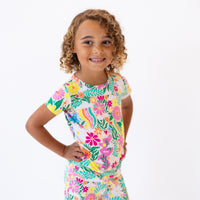 Child in The Second-Skin 2-Piece Short Sleeve Pajama, Rainbow Daisy Babe, butter-soft hand-drawn floral print.
