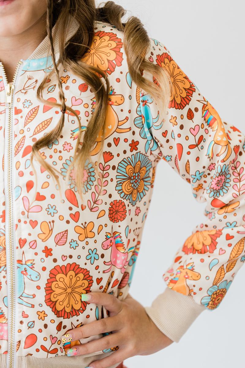Close-up of the 'Retro Unicorns' satin jacket for girls, showcasing the fun unicorn and floral print, perfect for trendy outfits.