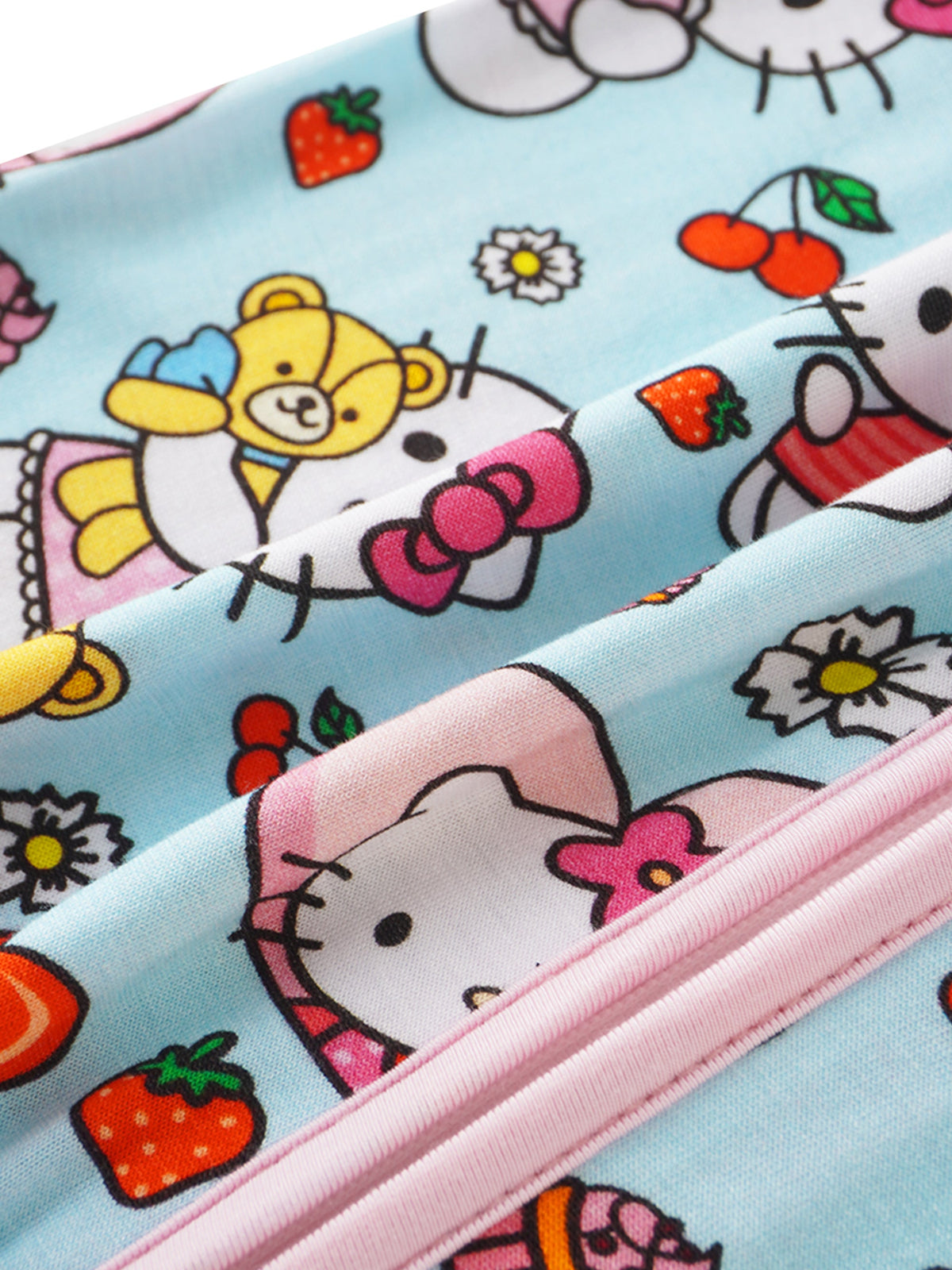 Macro view of vibrant red strawberries and white daisies printed on light blue bamboo fabric