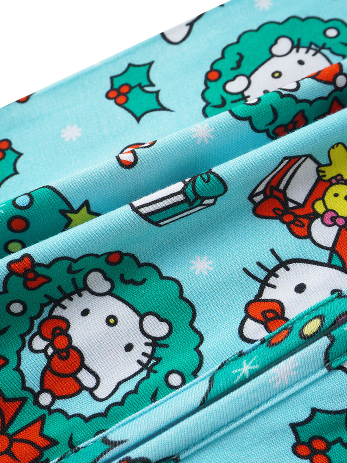 Macro shot of vibrant Hello Kitty wreath graphic printed on soft teal bamboo viscose fabric