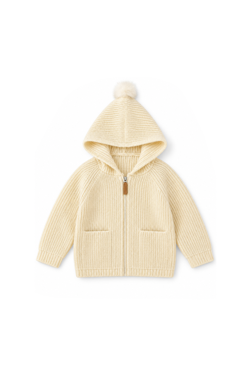 A cream-colored ribbed knit zip-up hoodie with a matching pom-pom hood, displayed flat against a solid white background.