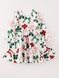 White girls Christmas dress featuring red, green, and pink bow prints on a festive long-sleeve holiday outfit.