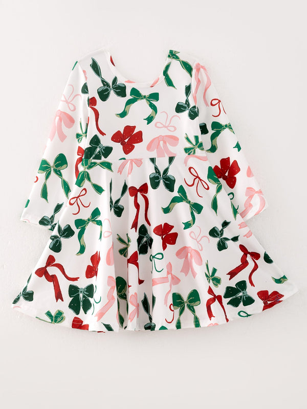 White girls Christmas dress featuring red, green, and pink bow prints on a festive long-sleeve holiday outfit.