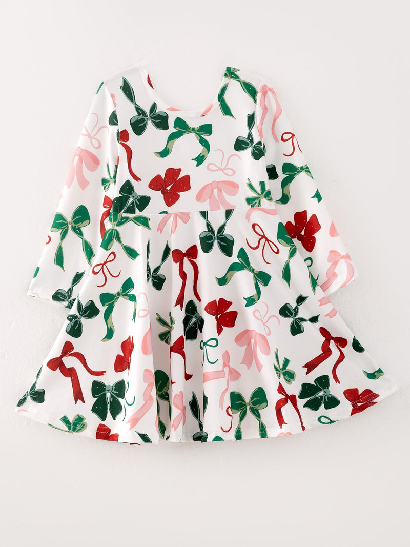 White girls Christmas dress featuring red, green, and pink bow prints on a festive long-sleeve holiday outfit.