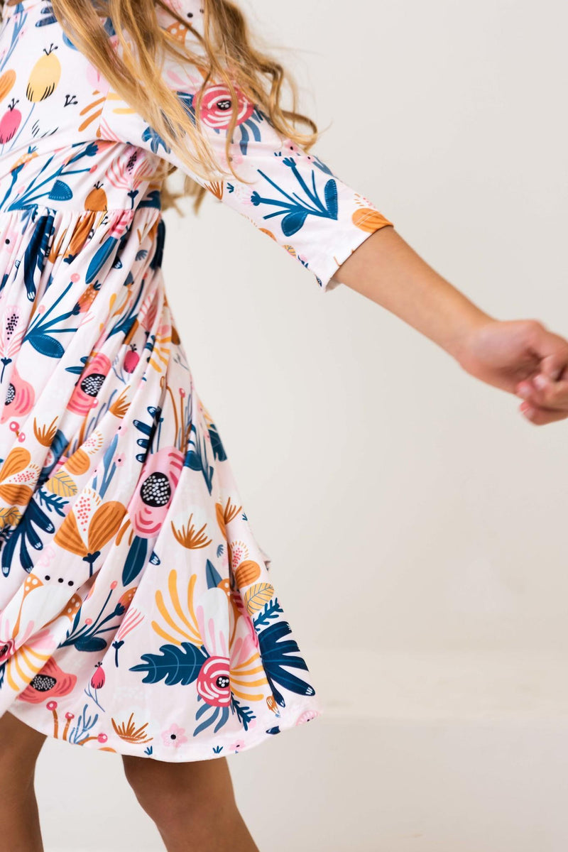 Close-up of the Blush Peony 3/4 Sleeve Pocket Twirl Dress, highlighting the soft polyester and spandex fabric ideal for comfort and twirling fun.