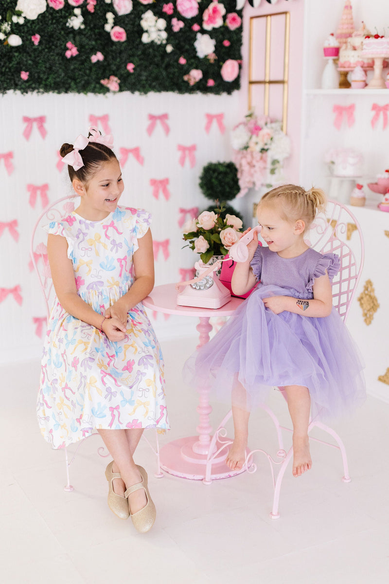 The Bow-tastic Flutter Sleeve Twirl Dress styled with Twirl Shorts for an adorable layered look, perfect for any occasion.