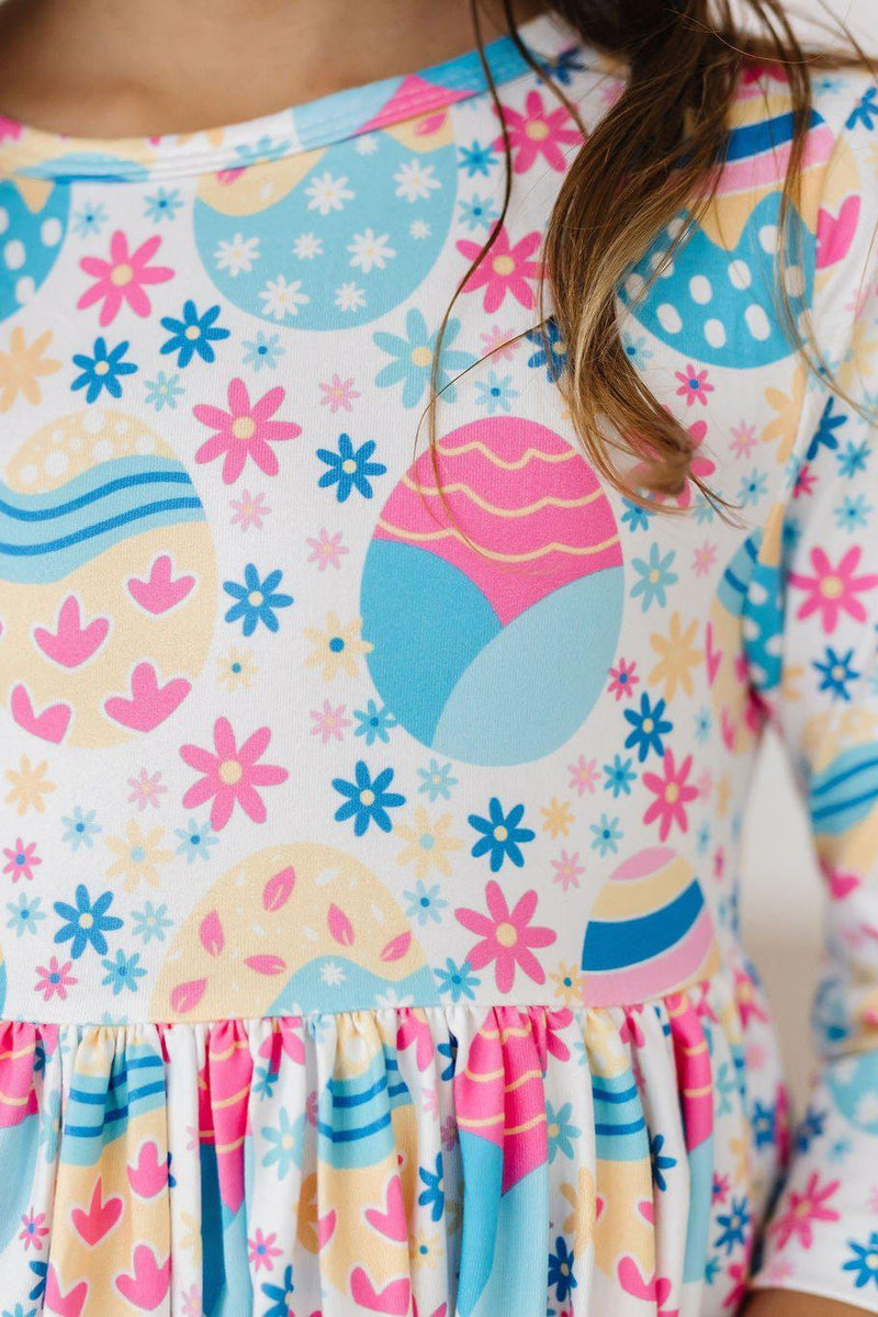 Close-up of the vibrant patterns on the Egg-cellent 3/4 Sleeve Pocket Twirl Dress, showcasing playful designs, perfect for twirling into fun!