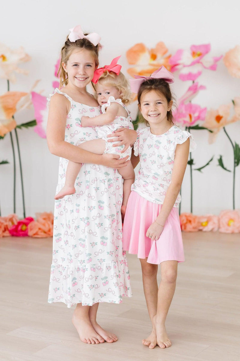 Close-up of the Berries & Bows Ruffle Maxi Dress showing soft fabric and colorful print, ideal for little girls.