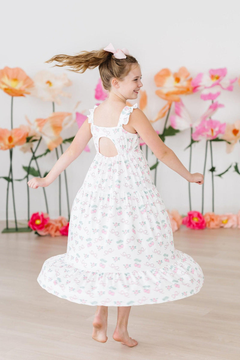 Back view of the Berries & Bows Ruffle Maxi Dress, featuring a trendy cutout and lightweight fabric, ideal for family gatherings and playdates.