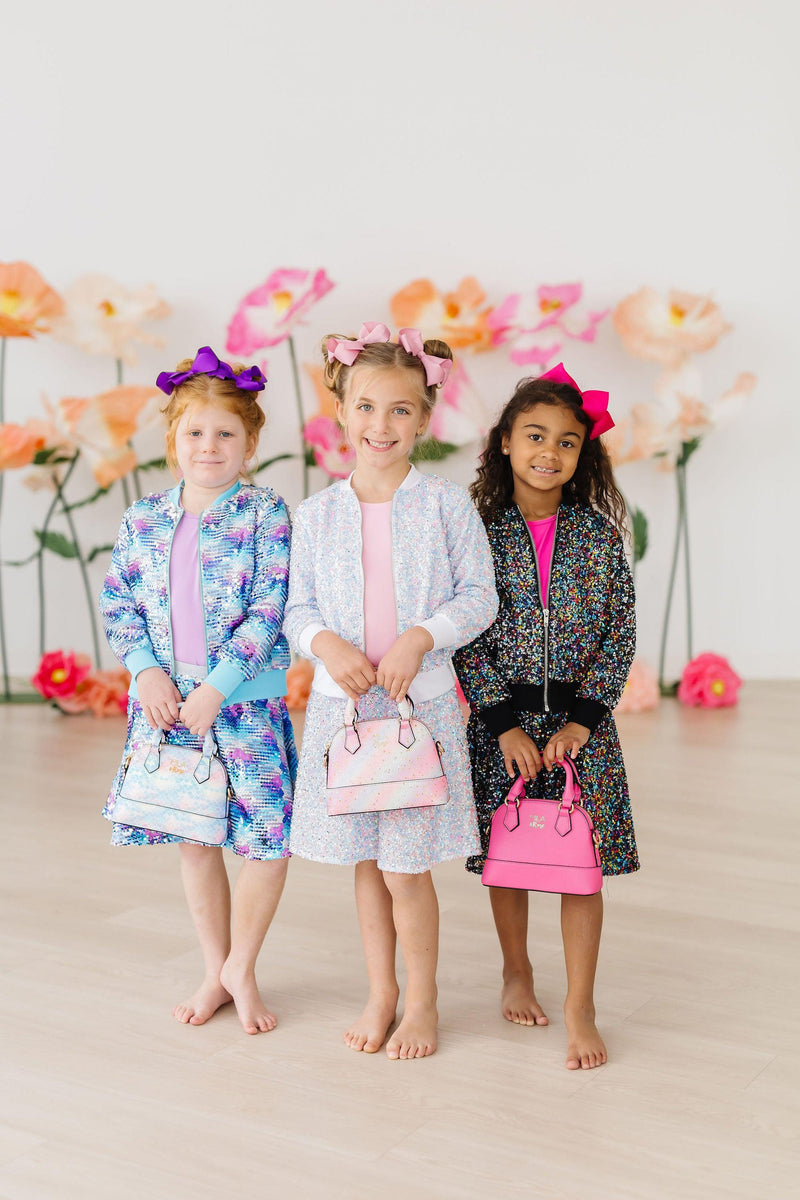 Girls wearing the delightful Confetti Sequin Twirl Skort, showcasing the fun built-in shorts and shimmering sequins for endless joyful movement.