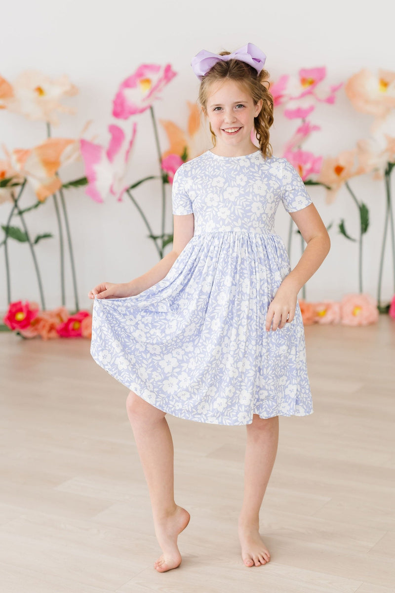 Back view of the Blossom Bliss S/S Pocket Twirl Dress, featuring the scoop back design for easy dressing by Mila & Rose®.