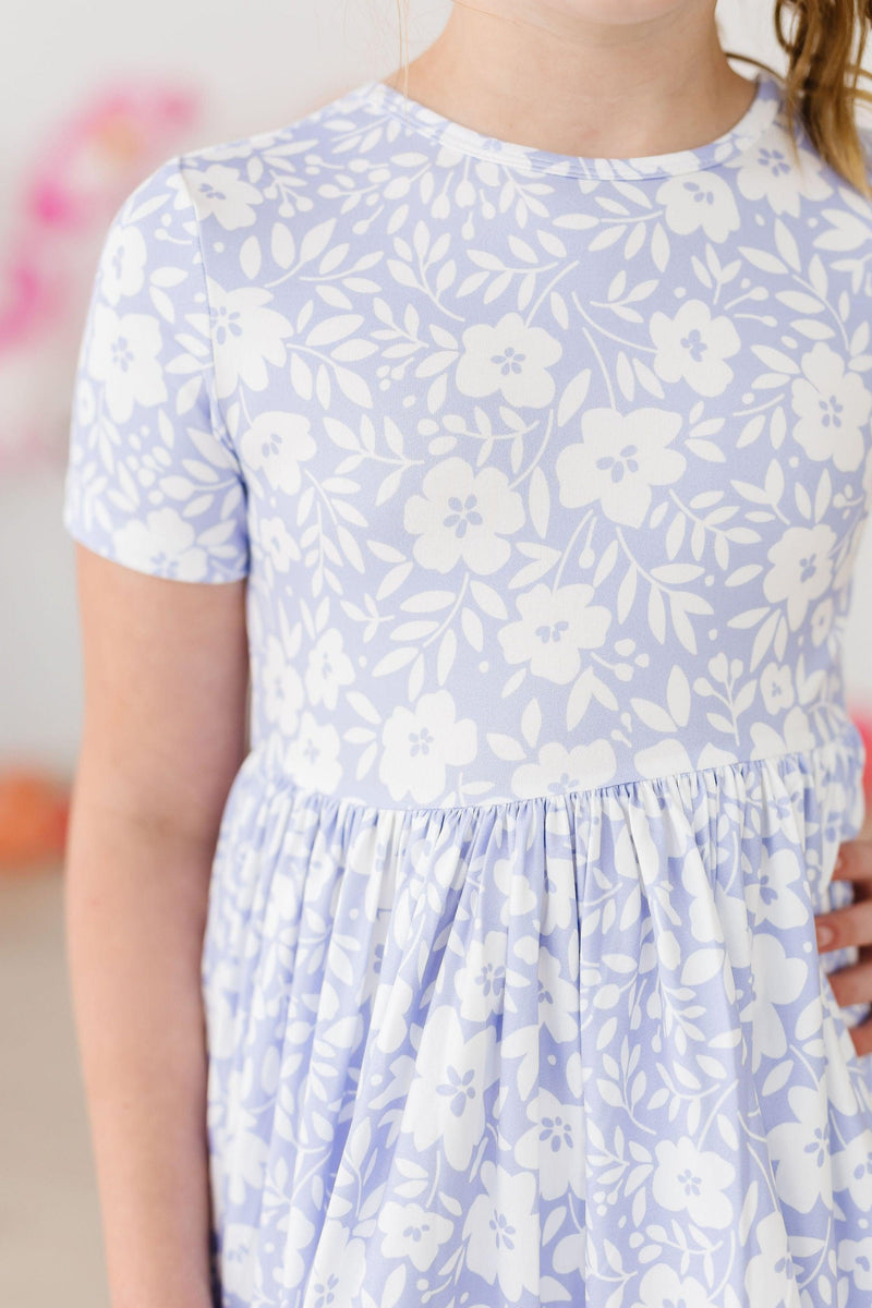 Blossom Bliss S/S Pocket Twirl Dress showcased on a child, highlighting its lovely design and playful features.