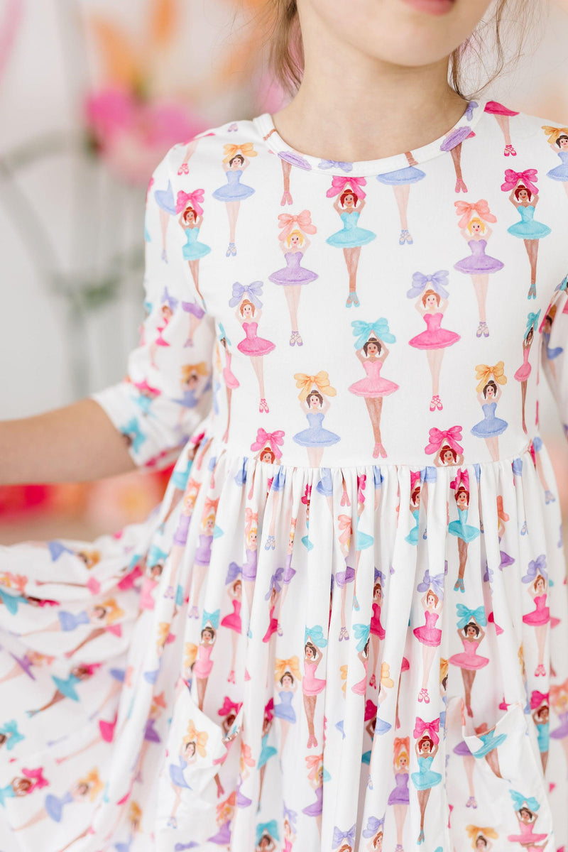 Close-up of Ballerina Bows 3/4 Sleeve Pocket Twirl Dress by Mila & Rose, showcasing the adorable scoop back and twirl factor for energetic little ones.