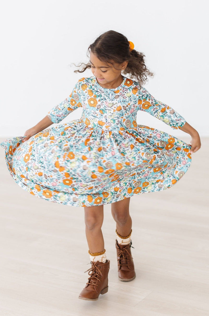 Girl joyfully twirling in the Vintage Vibes 3/4 Sleeve Twirl Dress for Girls, emphasizing the fun and elegance of the dress.