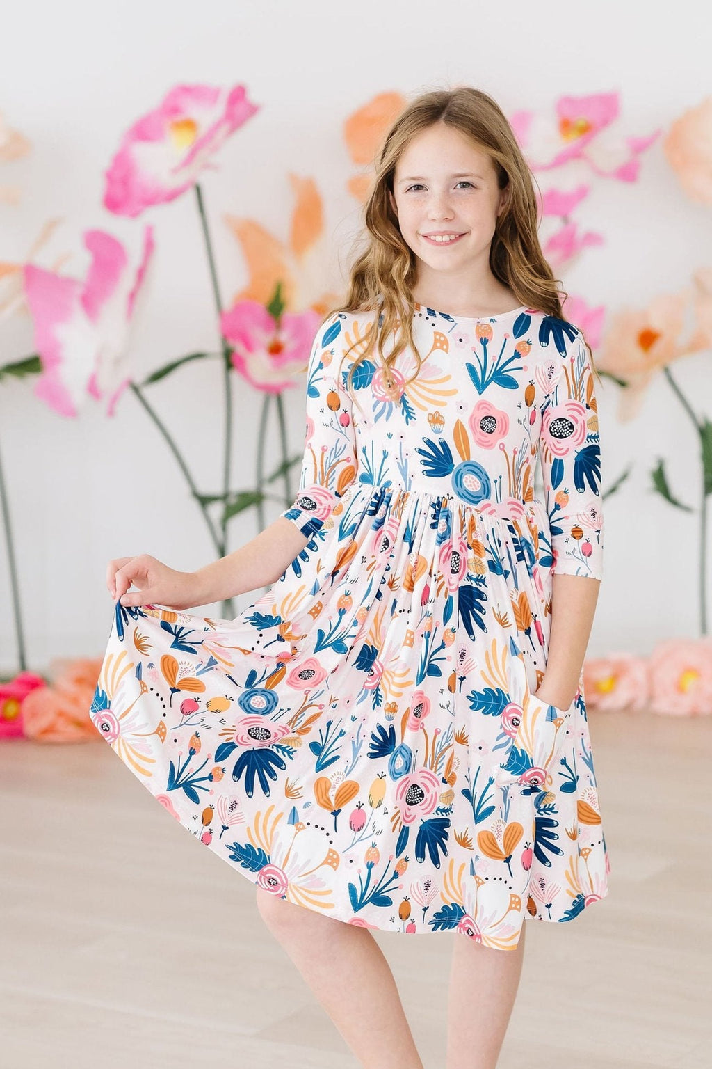 Blush Peony 3/4 Sleeve Pocket Twirl Dress by Mila & Rose, showcasing a vibrant floral design, perfect for twirling and play. Ideal for special occasions and everyday fun!