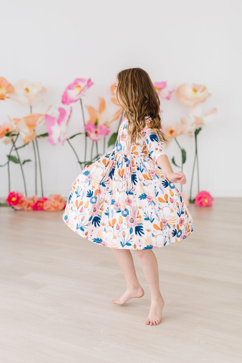 Close-up of the Blush Peony 3/4 Sleeve Pocket Twirl Dress highlighting the soft polyester and spandex fabric for ultimate comfort.