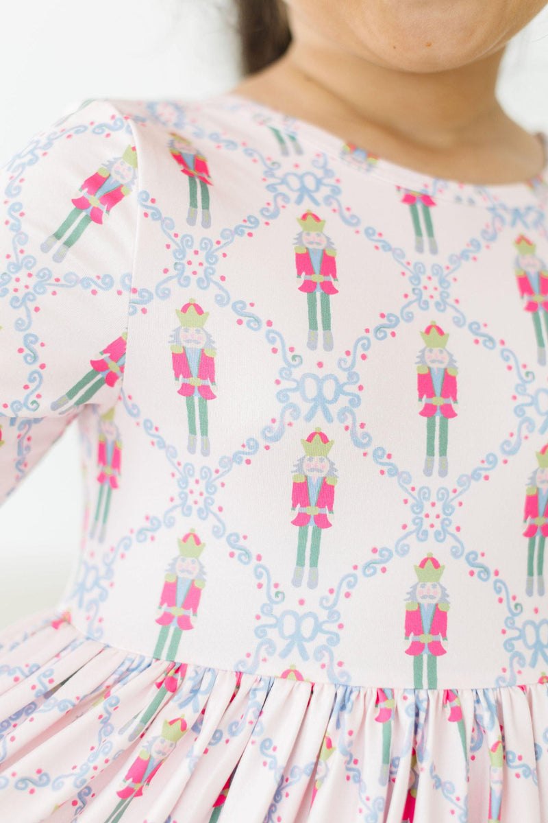 A close-up of the Pink Nutcracker 3/4 Sleeve Pocket Twirl Dress, highlighting the colorful nutcracker design and twirly skirt, ideal for holiday celebrations.