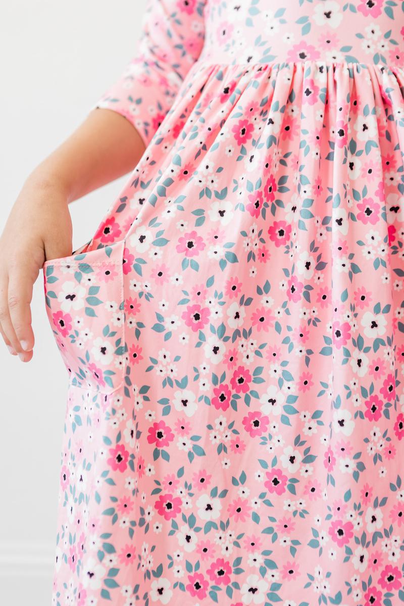 Close-up of the Azalea 3/4 Sleeve Pocket Twirl Dress showcasing its floral design and pockets for tiny treasures.