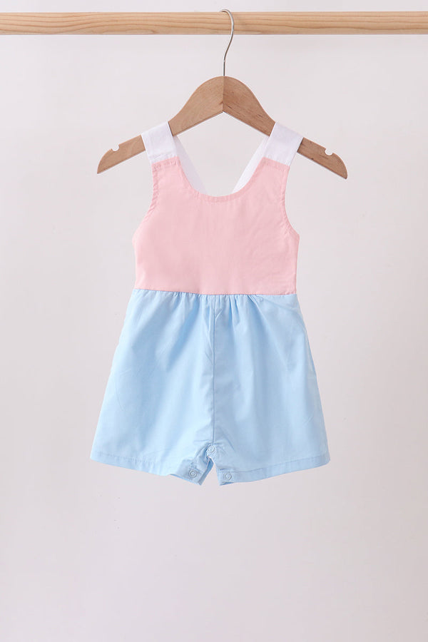 Pink and light-blue baby bubble romper with white shoulder straps and snap bottom.