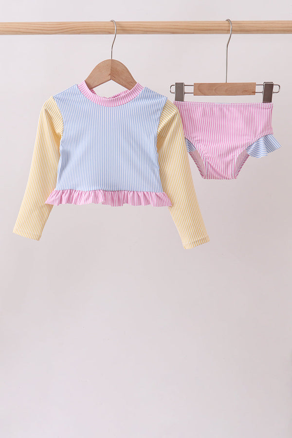Blue stripe Ruffle Rash Guard Set with yellow sleeves and pink ruffle hem, paired with pink striped bottoms.