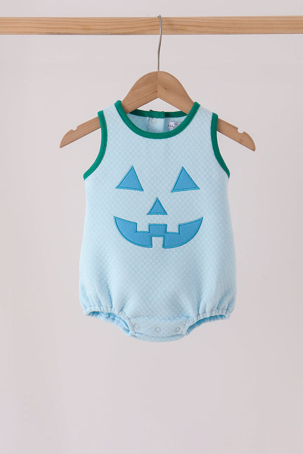Light blue bubble romper with green trim featuring a textured blue Jack-O-Lantern appliqué face on the front.