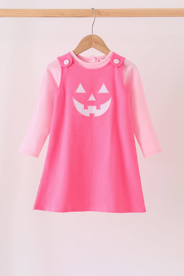 Pink Jack-O-Lantern applique dress with lighter pink long sleeves and button shoulder straps for Halloween.