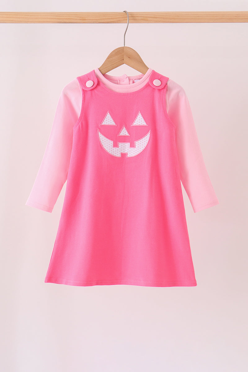 Pink Jack-O-Lantern applique dress with lighter pink long sleeves and button shoulder straps for Halloween.