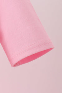 Close-up of pink cotton sleeve hem from the Jack-O-Lantern applique 2pc dress set for Halloween.