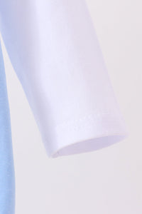 Close-up of soft blue cotton sleeve cuff with neat stitching from a Jack-O-Lantern applique bubble set for Halloween.