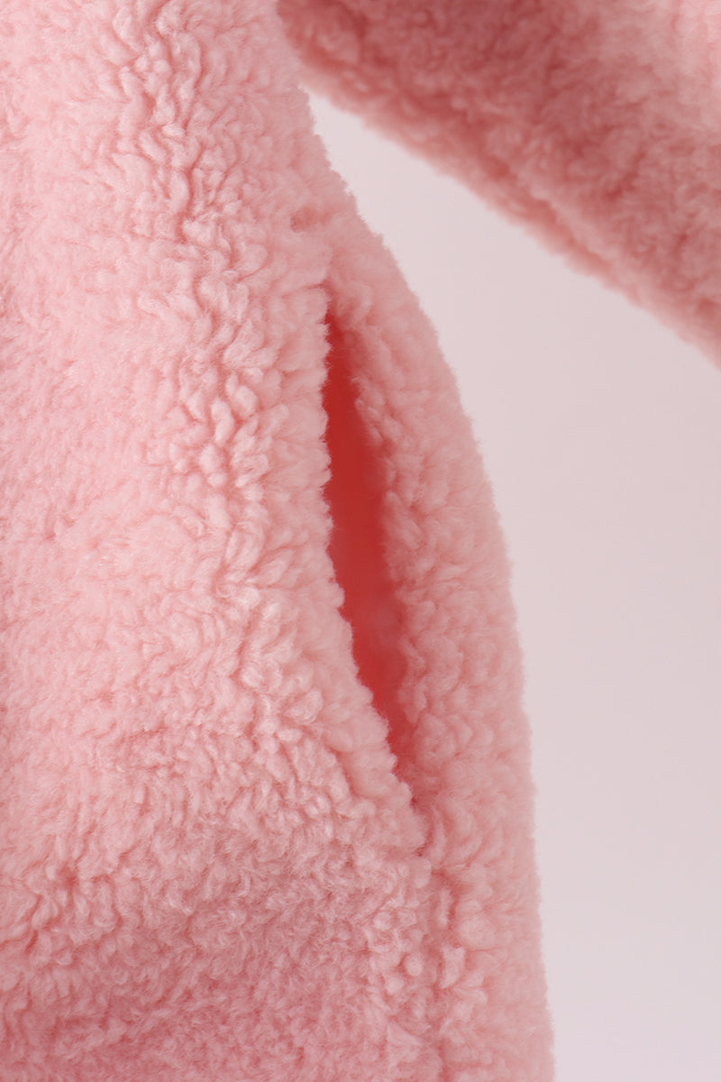 Soft pink fleece jacket featuring a cozy textured fabric and a convenient side pocket for casual layering.