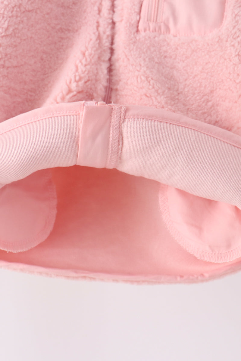 Soft pink fleece jacket sleeve with elastic cuff and smooth inner lining, perfect for cozy layering on cool days.