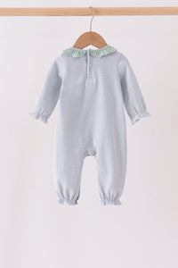 A baby hooded one-piece romper with thin blue and white horizontal stripes, featuring a pale green ruffled collar and ruffled cuffs, hanging on a wooden hanger against a plain light background.