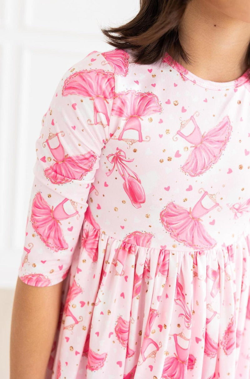 Close-up view of the Pirouette 3/4 Sleeve Pocket Twirl Dress, highlighting the beautiful ballet slippers and heart pattern on soft fabric.
