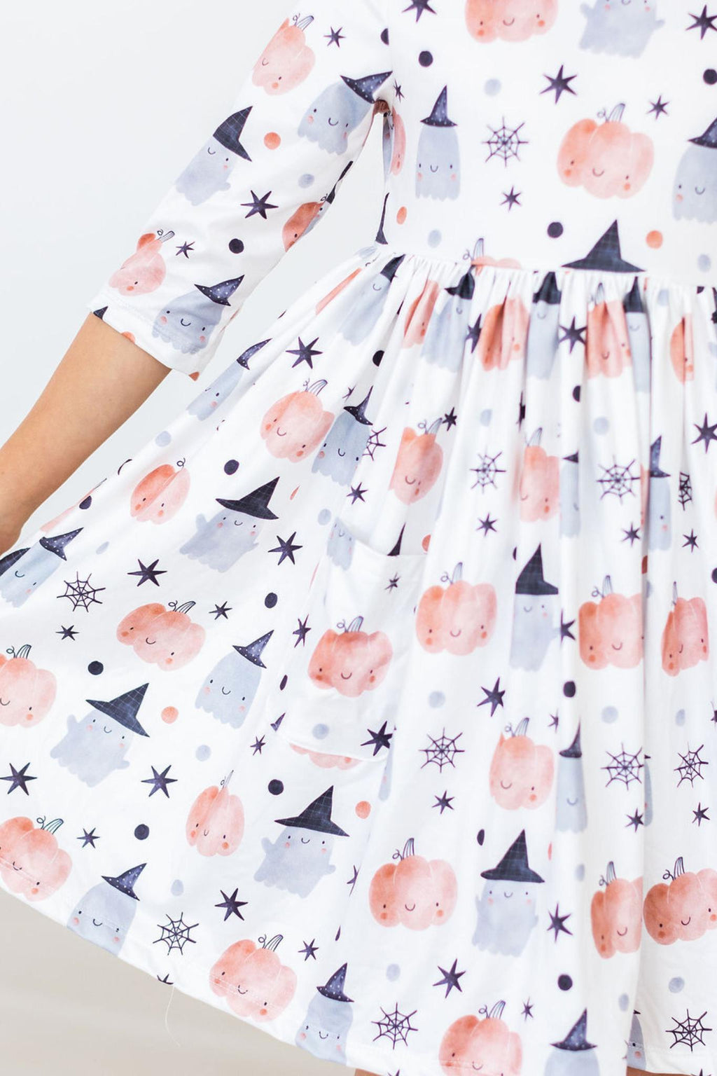 Peek-a-Boo 3/4 Sleeve Pocket Twirl Dress featuring playful pumpkin and ghost patterns, perfect for little adventurers on Halloween or any day of fun.