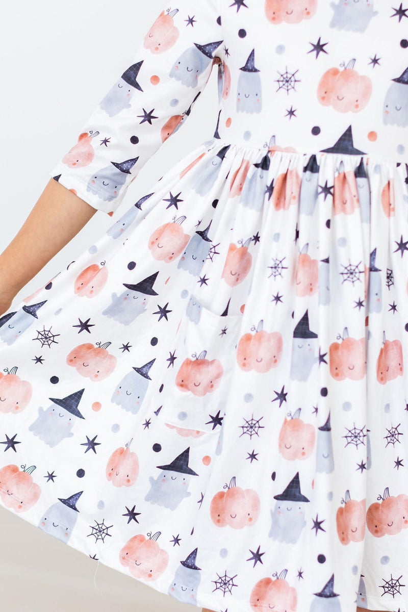 Peek-a-Boo 3/4 Sleeve Pocket Twirl Dress featuring playful pumpkin and ghost patterns, perfect for little adventurers on Halloween or any day of fun.