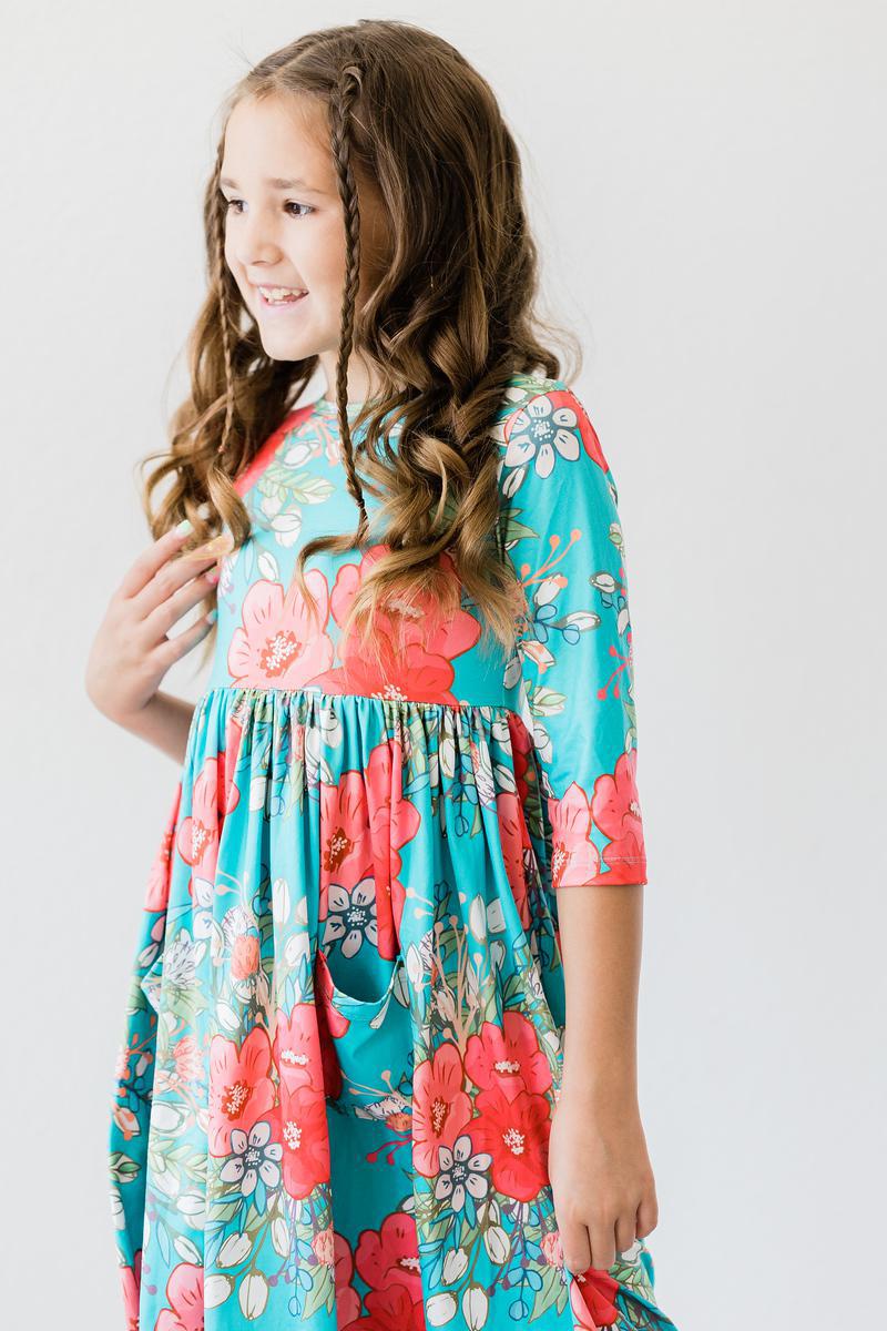 Enthusiastic girl smiling in the After the Rain 3/4 Sleeve Pocket Twirl Dress, a delightful twirl dress for girls ideal for everyday wear.