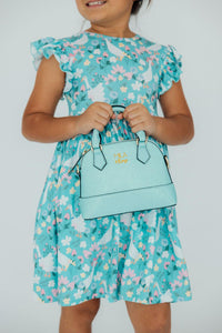Little girl holding sparkly aqua glitter crossbody purse. Perfect fashion accessory for girls, great gift for birthdays or holidays.