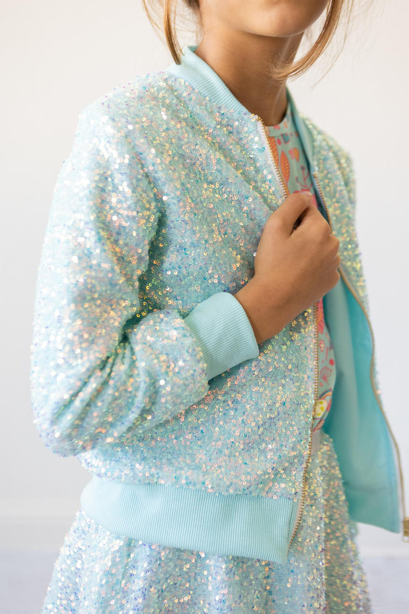 Close-up of Aqua Sequin Jacket for Girls, highlighting its sparkling detail and comfortable design, ideal for both special occasions and everyday wear.