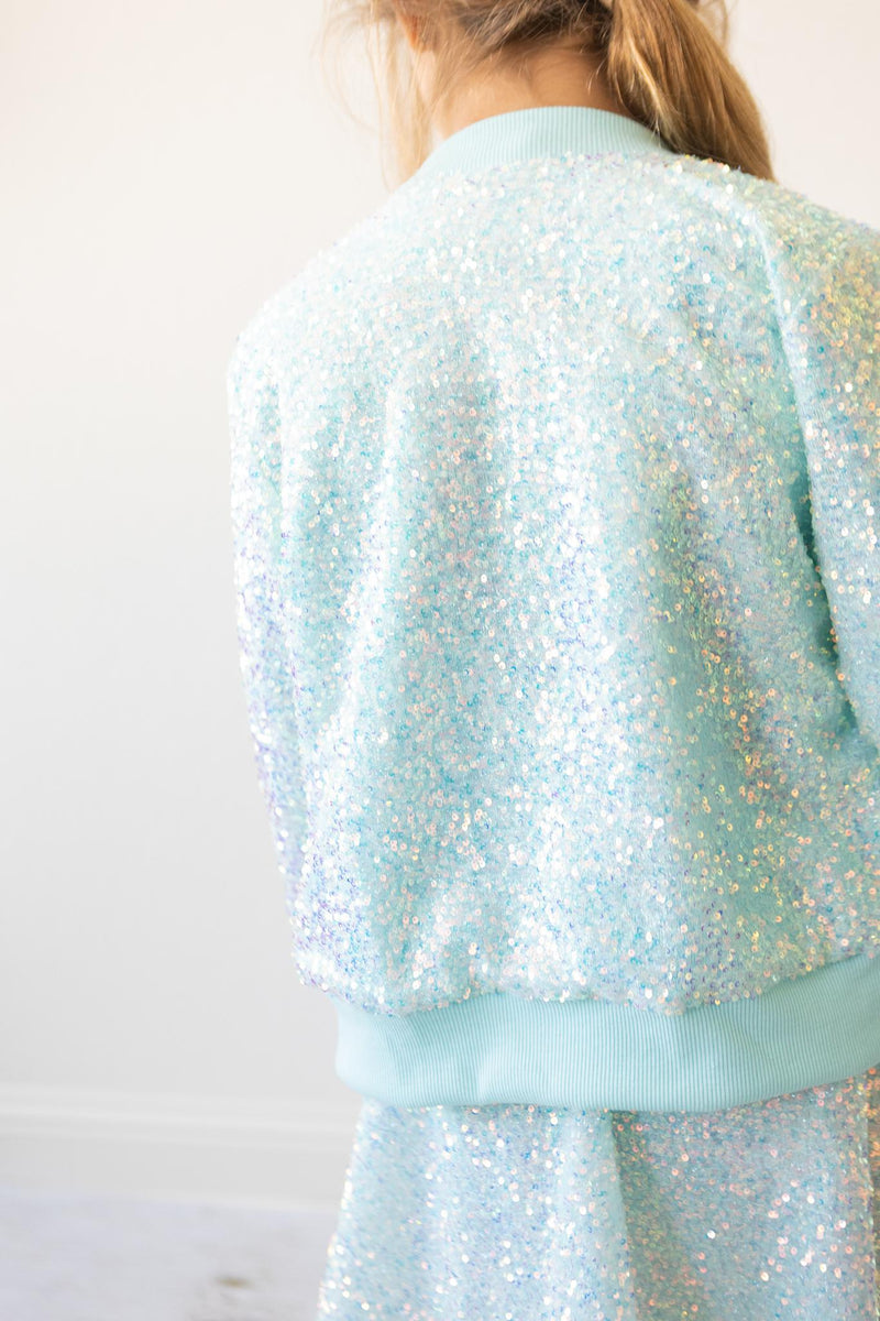 Back view of the Aqua Sequin Jacket for Girls, demonstrating a dazzling and playful style, perfect for adding a touch of glamour to any outfit.