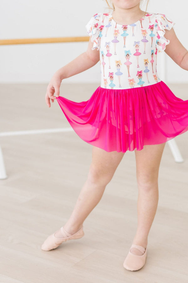Tiny dancer in a white Ballerina Bows Short Sleeve Twirl Leotard with colorful ballerina prints and a bright pink tutu.