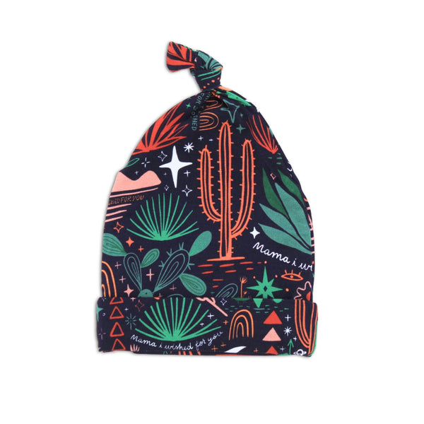 The SoftKnot Cap Desert Cactus Midnight bamboo newborn cap with knot top.